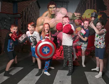 Children posing with props in front of The Hulk at Madame Tussauds Blackpool